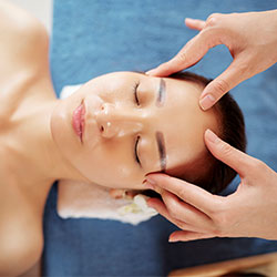 craniosacral session with hands on womans head