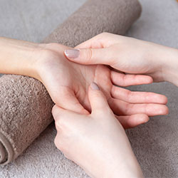 hand getting pressure point massage