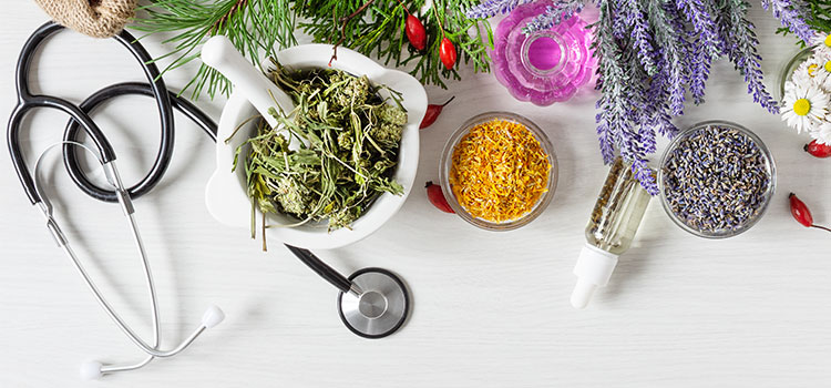 stethoscope arranged with colorful herbs and oil