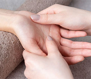 client receiving shiatsu therapy on their hand